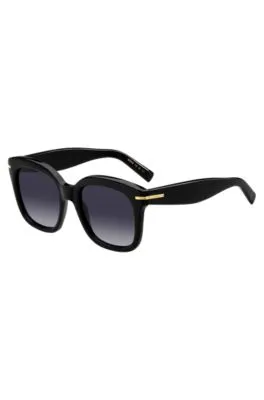 Gafas de sol de acetato negro con bisagras en tono dorado