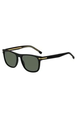 Gafas de sol de acetato negro con detalles metálicos en tono dorado