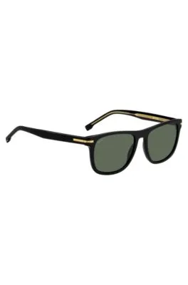 Gafas de sol de acetato negro con detalles metálicos en tono dorado