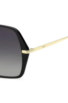 Gafas de sol de acetato negro con patillas en tono dorado